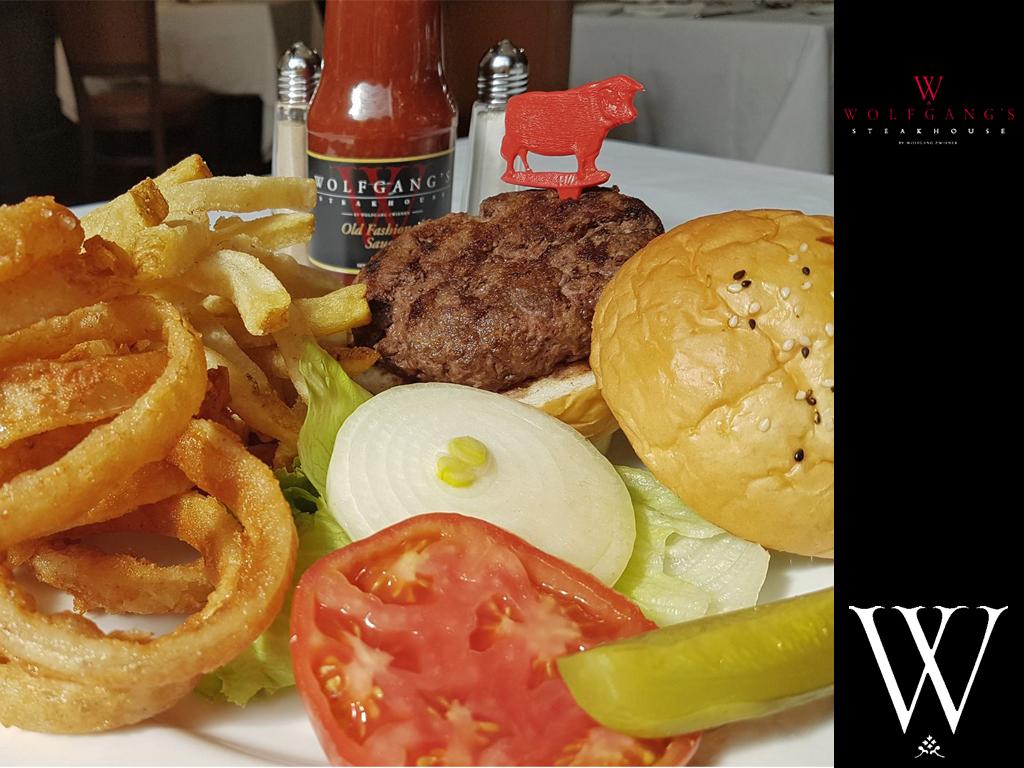 USDA Prime Beef Patty served with tomato  pickles  onion lettuce  steak fries and onion rings