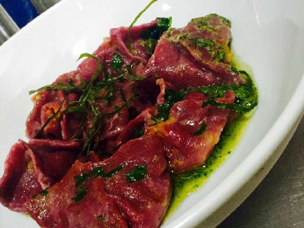 Beetroot raviolo with pumpkin and walnut pesto with salsa verde